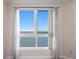 Large window showcasing waterfront view with sheer curtains providing natural light and privacy at 241 Riverside Dr # 704, Holly Hill, FL 32117