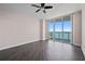 Spacious bedroom with tiled floors, natural light, ceiling fan, and sliding glass door access to a private balcony at 241 Riverside Dr # 704, Holly Hill, FL 32117