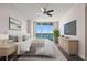 This is a bedroom with a bed, ceiling fan, and view of the water at 241 Riverside Dr # 704, Holly Hill, FL 32117