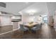 This dining room features a wood table with gray chairs, wood floors, and opens to the living room at 241 Riverside Dr # 704, Holly Hill, FL 32117