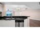 Modern kitchen with stainless steel dishwasher, granite counters, and an open view to the living space at 241 Riverside Dr # 704, Holly Hill, FL 32117