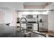 Modern kitchen featuring stainless steel appliances, granite counters, and a stylish backsplash at 241 Riverside Dr # 704, Holly Hill, FL 32117