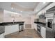 Well-lit kitchen featuring stainless appliances, tile flooring, granite countertops, and white cabinetry at 241 Riverside Dr # 704, Holly Hill, FL 32117