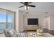 Relax in this living room with a ceiling fan, water views, and stylish wood floors at 241 Riverside Dr # 704, Holly Hill, FL 32117