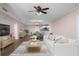 Bright living room featuring hardwood floors, ceiling fan, and an open view of the dining area and kitchen at 241 Riverside Dr # 704, Holly Hill, FL 32117