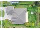 An aerial view showcasing the roof and backyard with a firepit of the home at 2454 Hyatt Creek Ln, Port Orange, FL 32128