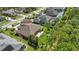 Aerial view of a house with lush green trees and a fire pit at 2454 Hyatt Creek Ln, Port Orange, FL 32128