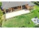 An aerial shot displays the covered patio and manicured lawn of the backyard at 2454 Hyatt Creek Ln, Port Orange, FL 32128