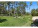Large grassy backyard with a fire pit and mature trees providing privacy at 2454 Hyatt Creek Ln, Port Orange, FL 32128