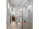 Bathroom features a shower with glass door, tile floors and access to Primary bedroom at 2454 Hyatt Creek Ln, Port Orange, FL 32128