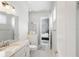 Bathroom featuring granite countertop, shower with glass door and access to Primary bedroom at 2454 Hyatt Creek Ln, Port Orange, FL 32128