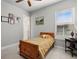 Bedroom with natural light, wood bed frame, ceiling fan and vintage decor at 2454 Hyatt Creek Ln, Port Orange, FL 32128