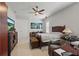 Spacious bedroom features ceiling fan, lounge chair, TV, and lots of natural light at 2454 Hyatt Creek Ln, Port Orange, FL 32128