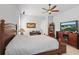 Inviting bedroom features ceiling fan, TV, lounge chair and lots of storage at 2454 Hyatt Creek Ln, Port Orange, FL 32128