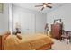 Bedroom boasts a wood bed frame, ceiling fan, and closet with double doors at 2454 Hyatt Creek Ln, Port Orange, FL 32128