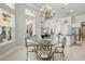 Charming dining area with ornate chairs, glass table, chandelier, and abundant natural light at 2454 Hyatt Creek Ln, Port Orange, FL 32128