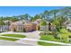 A wide-angle exterior view reveals the circular driveway and well-maintained landscaping at 2454 Hyatt Creek Ln, Port Orange, FL 32128