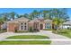 The exterior front view shows a nicely landscaped yard with a circular driveway at 2454 Hyatt Creek Ln, Port Orange, FL 32128