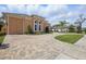 Stunning exterior view of the home, featuring a brick driveway and lush landscaping at 2454 Hyatt Creek Ln, Port Orange, FL 32128