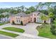 Stunning single-story home featuring a manicured front lawn, circular driveway and elegant arched windows at 2454 Hyatt Creek Ln, Port Orange, FL 32128