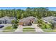 Wide angle street view of the home with lush landscaping and circular driveway at 2454 Hyatt Creek Ln, Port Orange, FL 32128