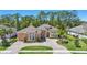 Charming house with lush landscaping, striking architectural features, and circular driveway at 2454 Hyatt Creek Ln, Port Orange, FL 32128