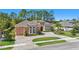 Full exterior home view showcases the circular paver driveway with meticulous landscaping at 2454 Hyatt Creek Ln, Port Orange, FL 32128