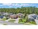 Stunning home featuring a beautiful lawn, tall trees, and a circular driveway for welcoming guests at 2454 Hyatt Creek Ln, Port Orange, FL 32128