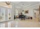 Elegant foyer with high ceilings, tile flooring, decorative glass double-doors, and a grand piano at 2454 Hyatt Creek Ln, Port Orange, FL 32128