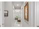 Hallway with art leading to bedroom featuring tray ceilings and pendant lighting with window views at 2454 Hyatt Creek Ln, Port Orange, FL 32128