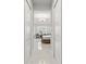 Hallway with tile flooring leading to bedroom with tray ceilings and pendant lighting at 2454 Hyatt Creek Ln, Port Orange, FL 32128