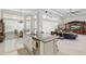 Open-concept kitchen featuring a large island with bar stools, seamless flow into the living area and dining nook at 2454 Hyatt Creek Ln, Port Orange, FL 32128