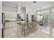 Spacious kitchen featuring a large island, modern cabinetry, granite countertops, and stainless steel appliances at 2454 Hyatt Creek Ln, Port Orange, FL 32128