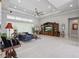 Bright living room with a tray ceiling, ceiling fan, comfortable seating, and ample natural light at 2454 Hyatt Creek Ln, Port Orange, FL 32128