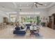 Large living room with lots of light, tile floors, ceiling fan and access to porch at 2454 Hyatt Creek Ln, Port Orange, FL 32128