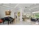 Large living room area boasting marble floors, recessed lights, and an open layout featuring a grand piano at 2454 Hyatt Creek Ln, Port Orange, FL 32128