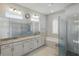 Modern main bathroom features double vanity, soaking tub, glass enclosed shower and natural light at 2454 Hyatt Creek Ln, Port Orange, FL 32128