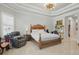 Serene main bedroom with a tray ceiling, neutral color palette, and comfortable furnishings at 2454 Hyatt Creek Ln, Port Orange, FL 32128