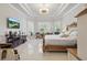 Luxurious main bedroom with a tray ceiling, comfortable seating, and large windows at 2454 Hyatt Creek Ln, Port Orange, FL 32128