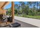 Covered patio with comfortable seating, offering views of the expansive backyard at 2454 Hyatt Creek Ln, Port Orange, FL 32128