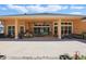 Outdoor patio with fireplace, ceiling fans, and large sliding glass doors at 2454 Hyatt Creek Ln, Port Orange, FL 32128