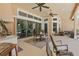 Spacious covered patio with ceiling fans, outdoor seating, and nature views at 2454 Hyatt Creek Ln, Port Orange, FL 32128