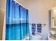 Clean bathroom with beach-themed shower curtain and coordinated towel set at 2480 Ocean Shore Blvd # 120, Ormond Beach, FL 32176