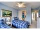 Comfortable bedroom with twin beds, ceiling fan, and convenient bathroom access at 2480 Ocean Shore Blvd # 120, Ormond Beach, FL 32176
