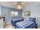 Charming bedroom featuring two twin beds, a ceiling fan, and beach-inspired decor at 2480 Ocean Shore Blvd # 120, Ormond Beach, FL 32176