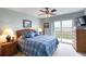 Comfortable bedroom with waterfront views, ceiling fan, and relaxing atmosphere at 2480 Ocean Shore Blvd # 120, Ormond Beach, FL 32176
