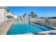 Inviting community pool surrounded by lounge chairs and lush landscaping at 2480 Ocean Shore Blvd # 120, Ormond Beach, FL 32176