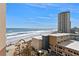 Breathtaking aerial view showcasing a beach with beachfront condo buildings against blue skies at 2515 S Atlantic Ave # 509, Daytona Beach, FL 32118