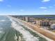 Picturesque aerial view of a coastal condominium complex along a beautiful beach and coastline at 2515 S Atlantic Ave # 509, Daytona Beach, FL 32118