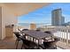 Spacious balcony with dining table and ocean views, ideal for entertaining and enjoying the coastal breeze at 2515 S Atlantic Ave # 509, Daytona Beach, FL 32118